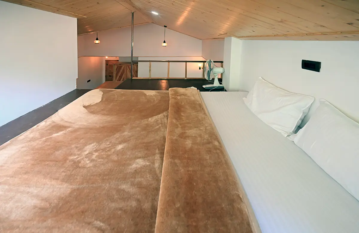 bedding-at-upper-level-of-attic-room